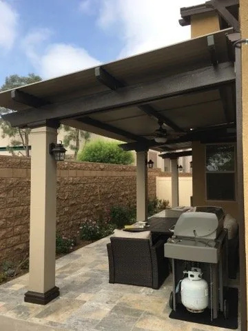 Traditional Solara adjustable louvered cover on an Alumawood beam with decorative cuts, carried on three columns